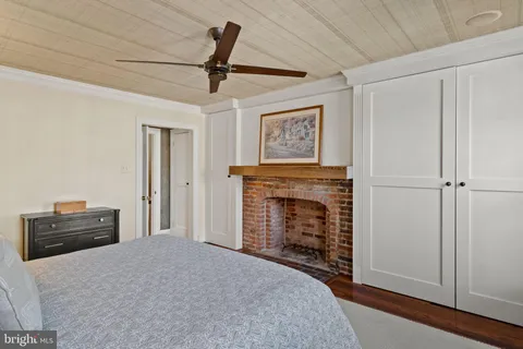 a bedroom with furniture and a fireplace