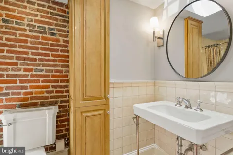 a bathroom with a sink a mirror and a shower
