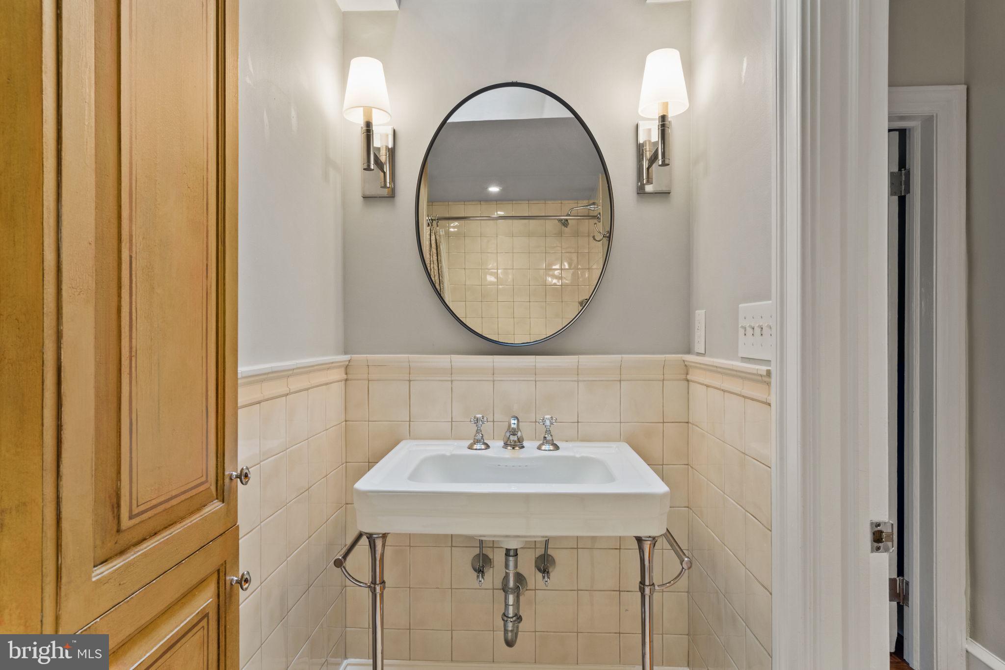 228 Spruce Street Philadelphia, PA 19106 - Photo 25 of 36 a bathroom with a sink and a mirror