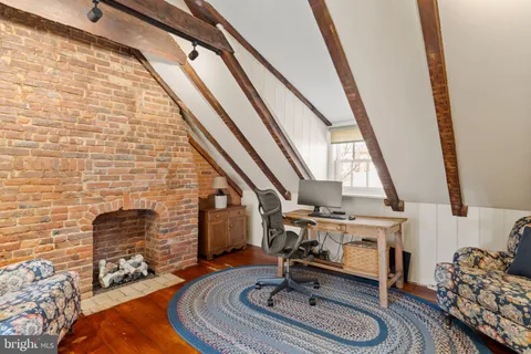 a view of a livingroom with wooden floor and stairs
