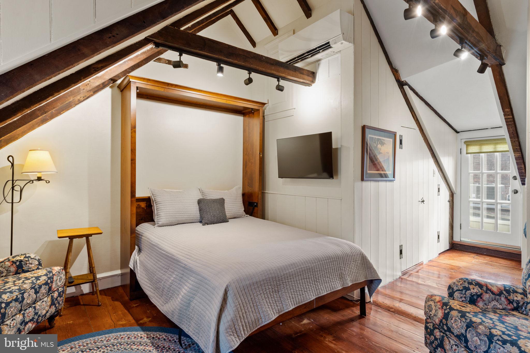 228 Spruce Street Philadelphia, PA 19106 - Photo 32 of 36 a bedroom with a bed and a flat tv screen on the dresser