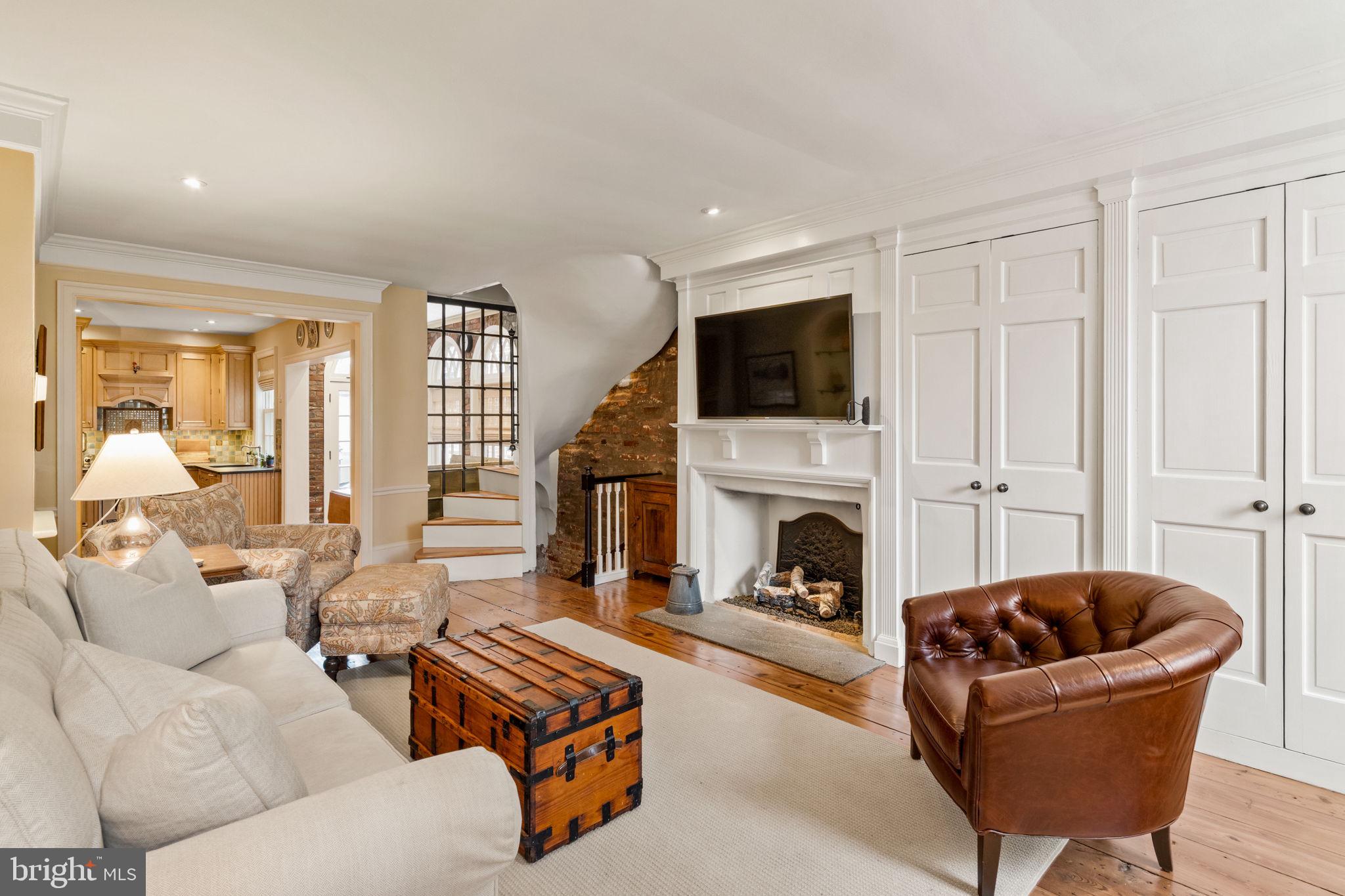 228 Spruce Street Philadelphia, PA 19106 - Photo 6 of 36 a living room with furniture a fireplace and a flat screen tv