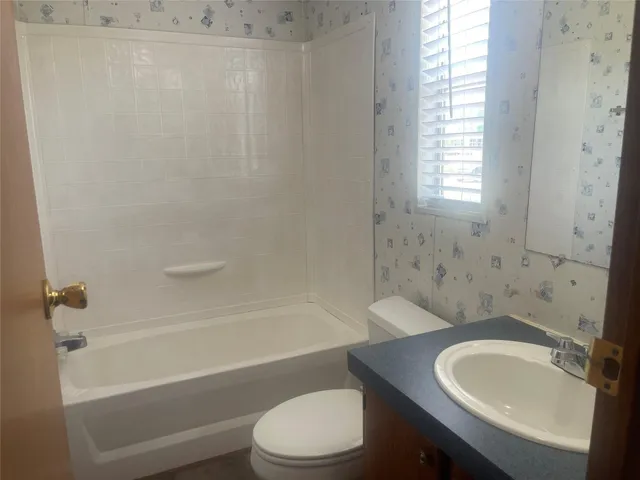 a bathroom with a sink toilet and a bathtub