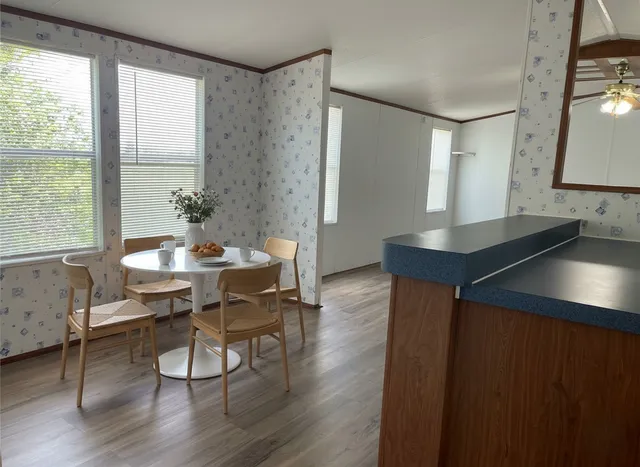 a view of a dining room with furniture and wooden floor