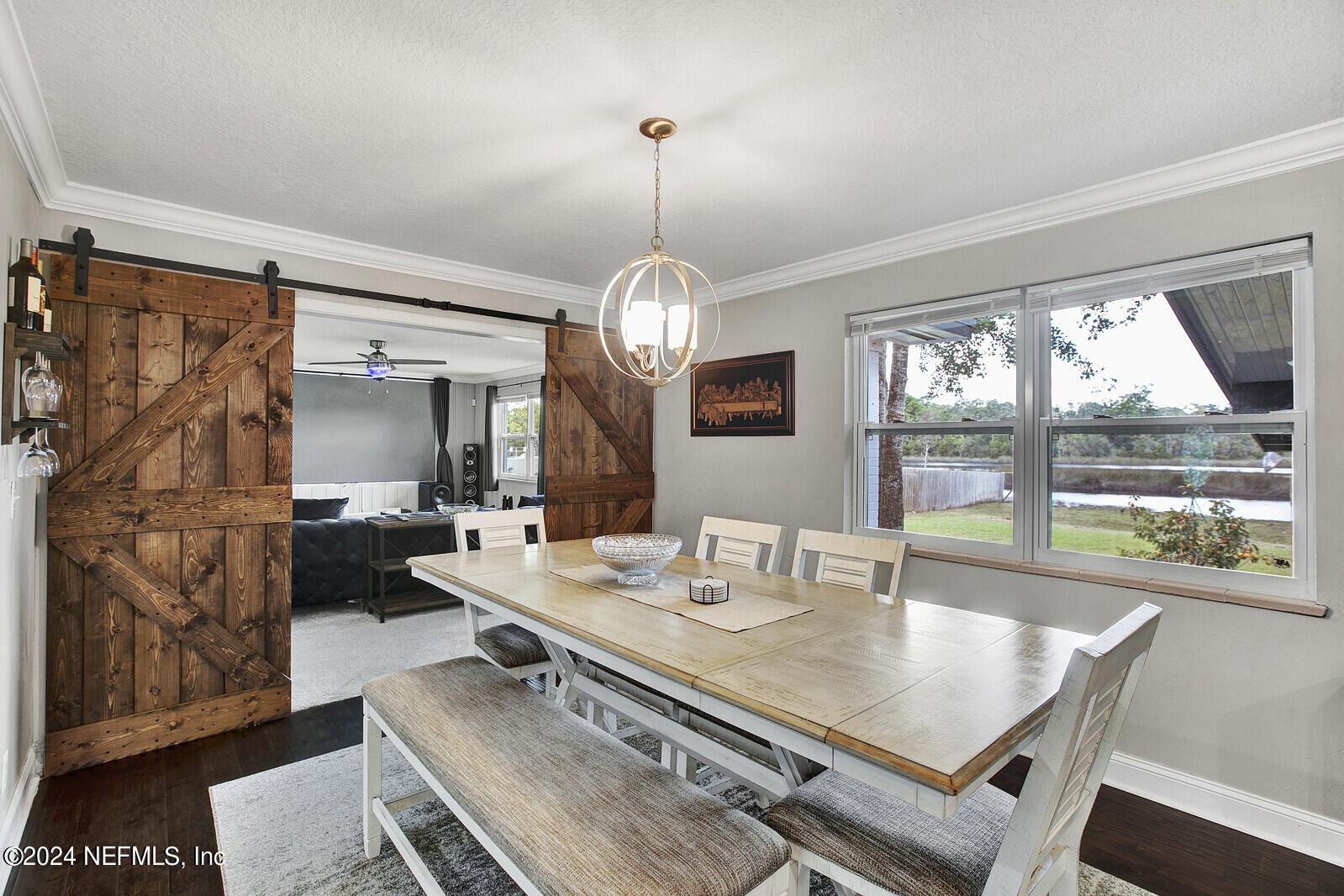 2907 Ribault Scenic Drive Jacksonville, FL 32208 - Photo 11 of 49 a view of a dining room with furniture wooden floor and a chandelier
