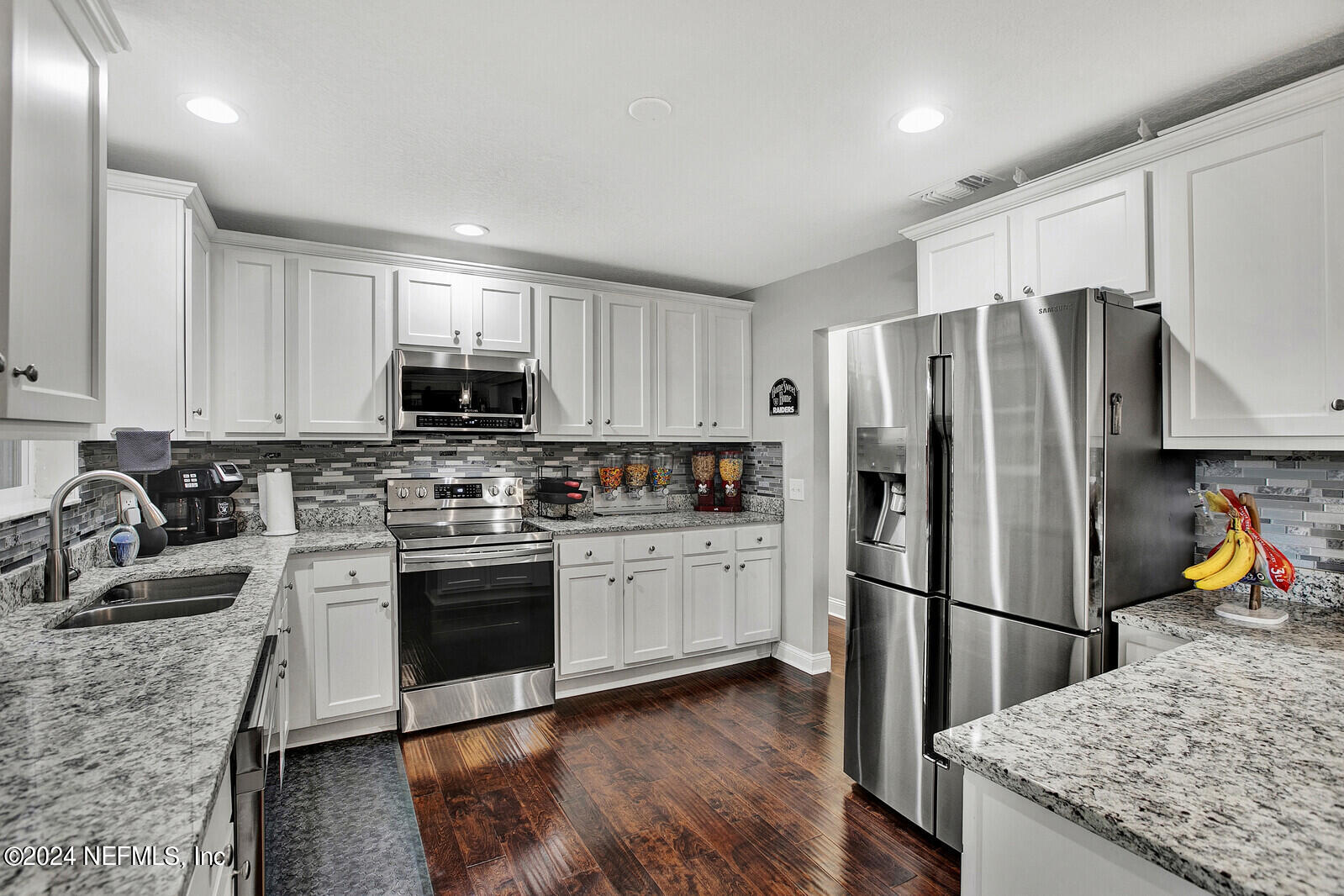 2907 Ribault Scenic Drive Jacksonville, FL 32208 - Photo 19 of 49 a kitchen with stainless steel appliances granite countertop a refrigerator stove microwave and sink