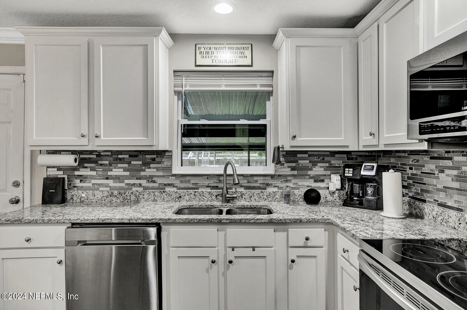 2907 Ribault Scenic Drive Jacksonville, FL 32208 - Photo 20 of 49 a kitchen with stainless steel appliances granite countertop a sink and a stove