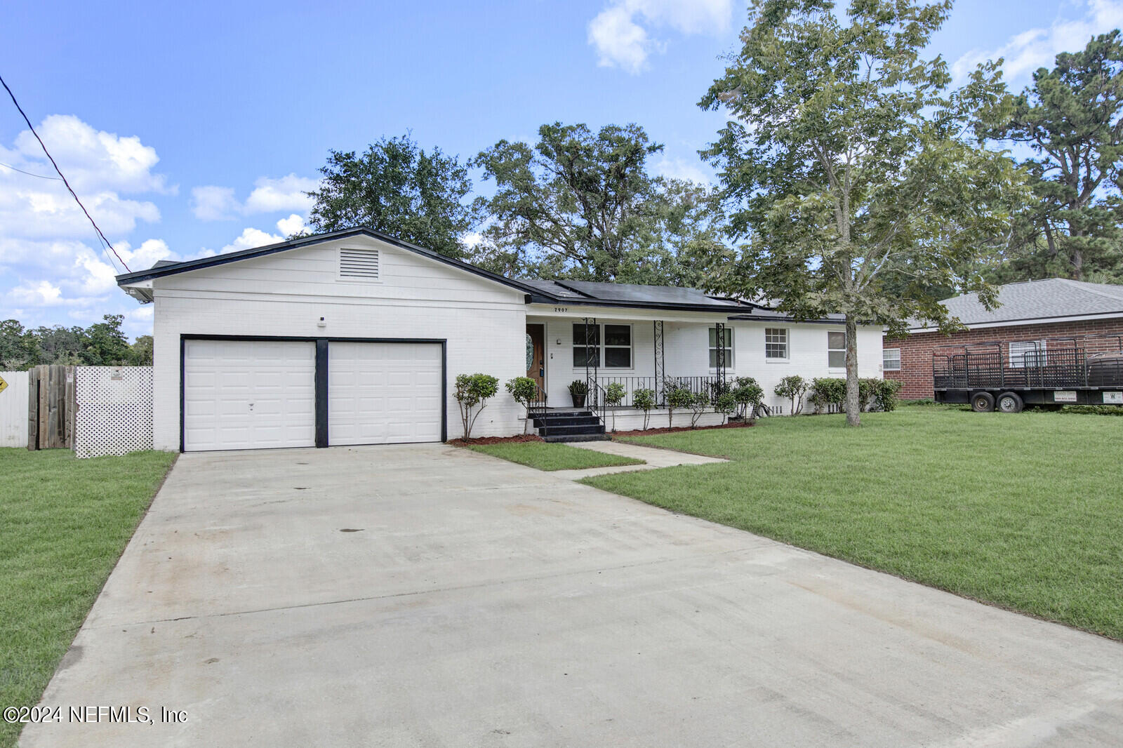 2907 Ribault Scenic Drive Jacksonville, FL 32208 - Photo 2 of 49 a front view of a house with a garden and plants