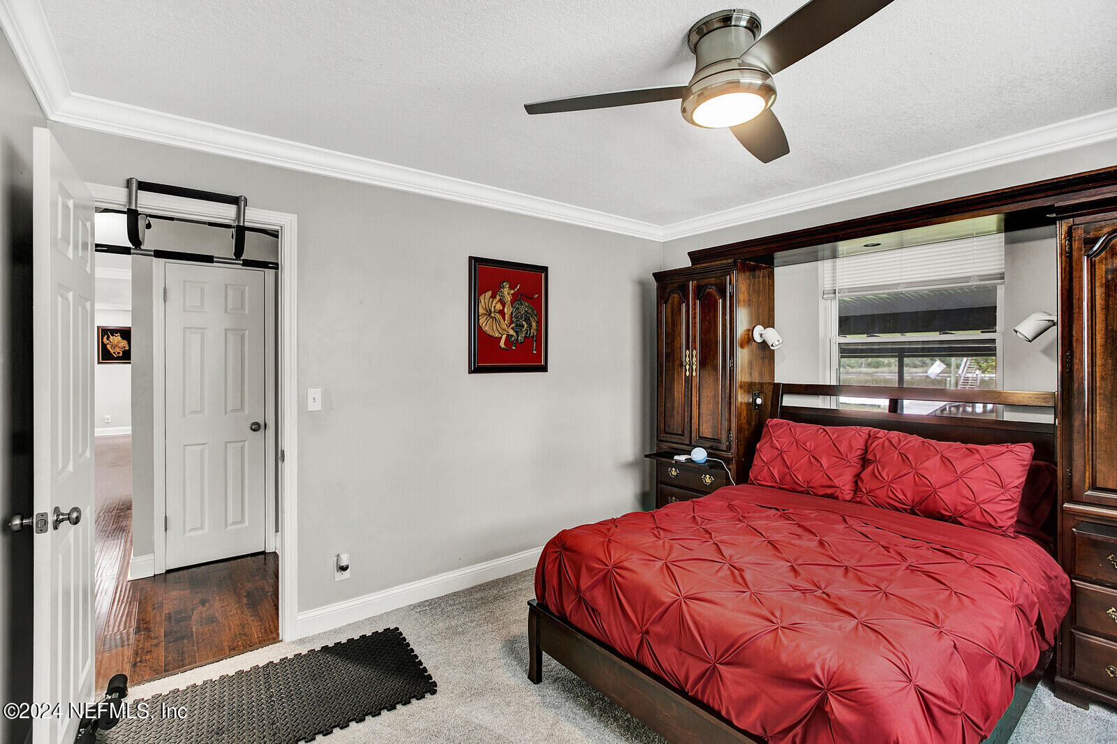 2907 Ribault Scenic Drive Jacksonville, FL 32208 - Photo 23 of 49 a bedroom with a bed and a chandelier