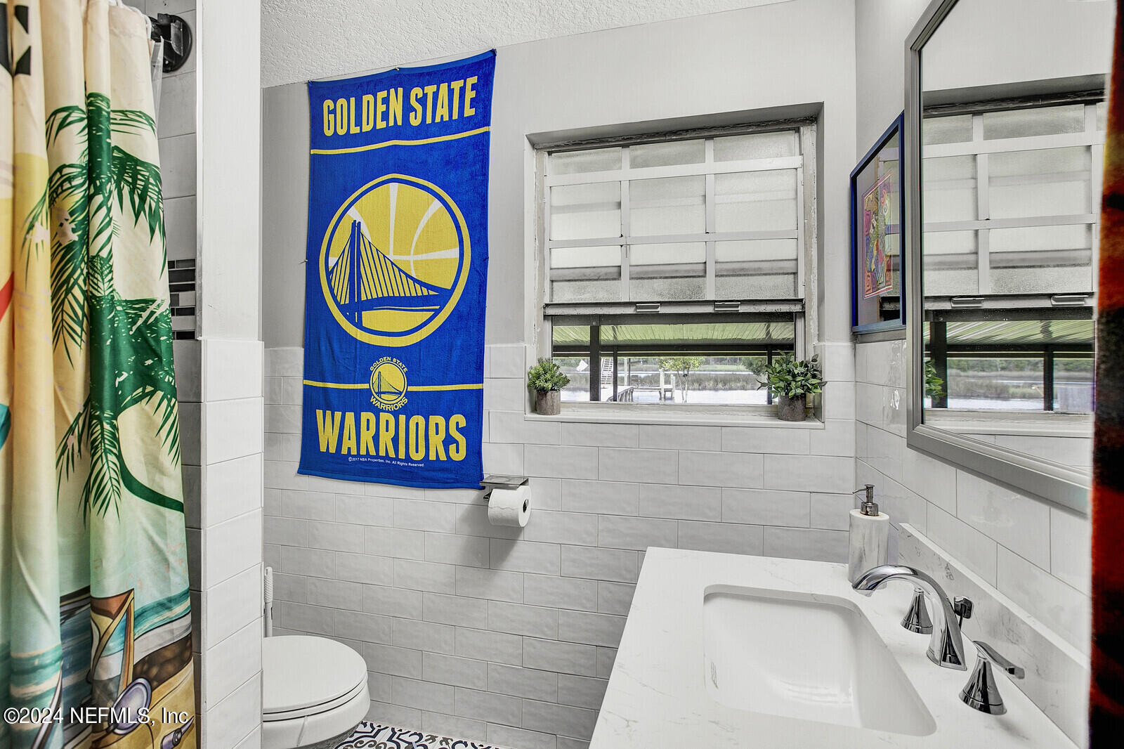 2907 Ribault Scenic Drive Jacksonville, FL 32208 - Photo 25 of 49 a bathroom with a toilet a sink and a window