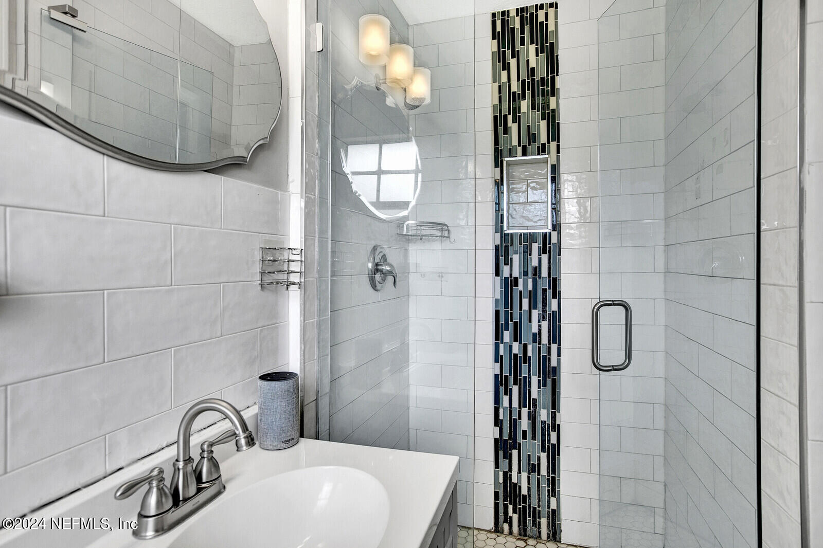 2907 Ribault Scenic Drive Jacksonville, FL 32208 - Photo 28 of 49 a bathroom with a sink a mirror and shower