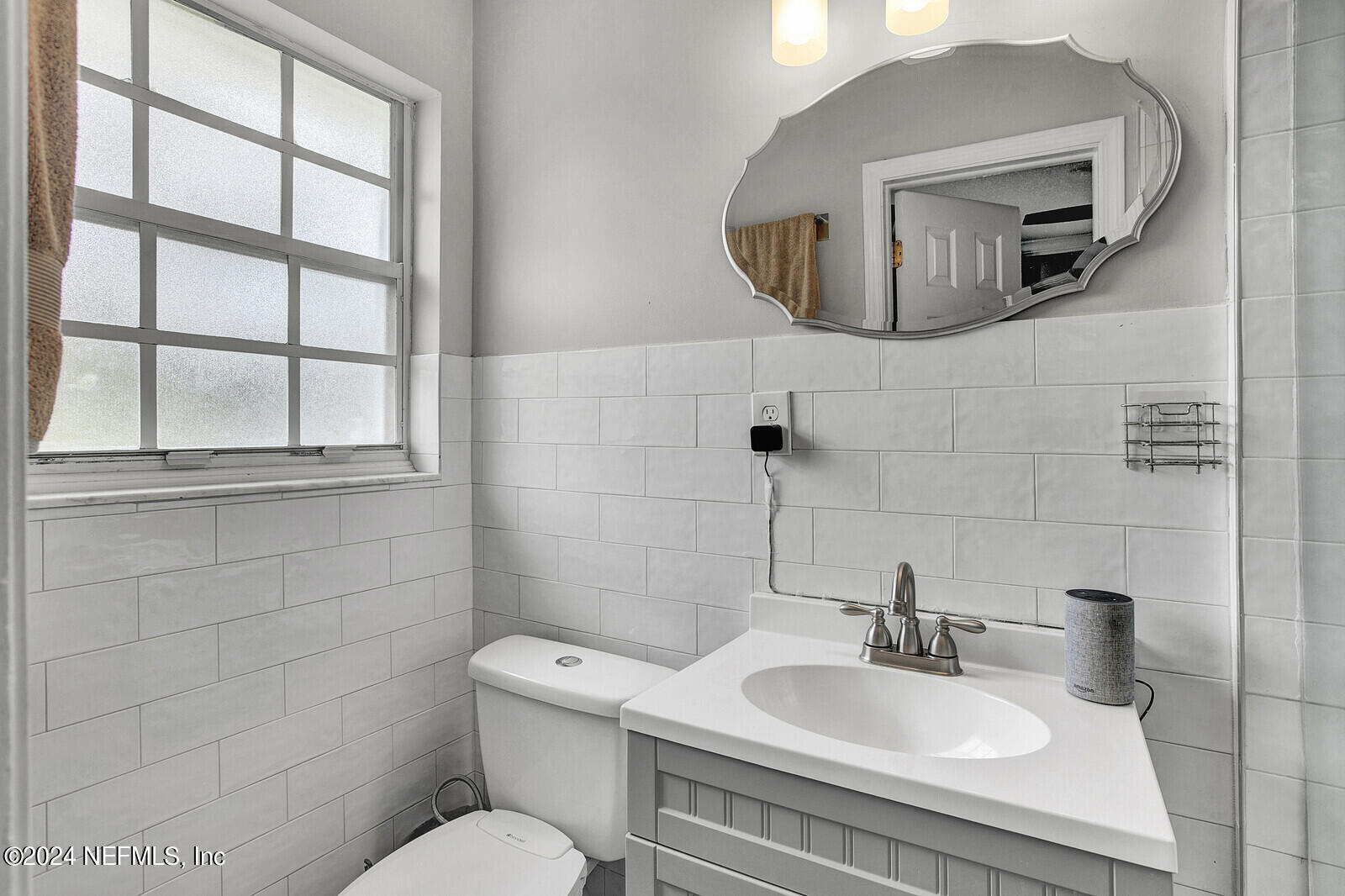 2907 Ribault Scenic Drive Jacksonville, FL 32208 - Photo 29 of 49 a bathroom with a toilet sink and mirror