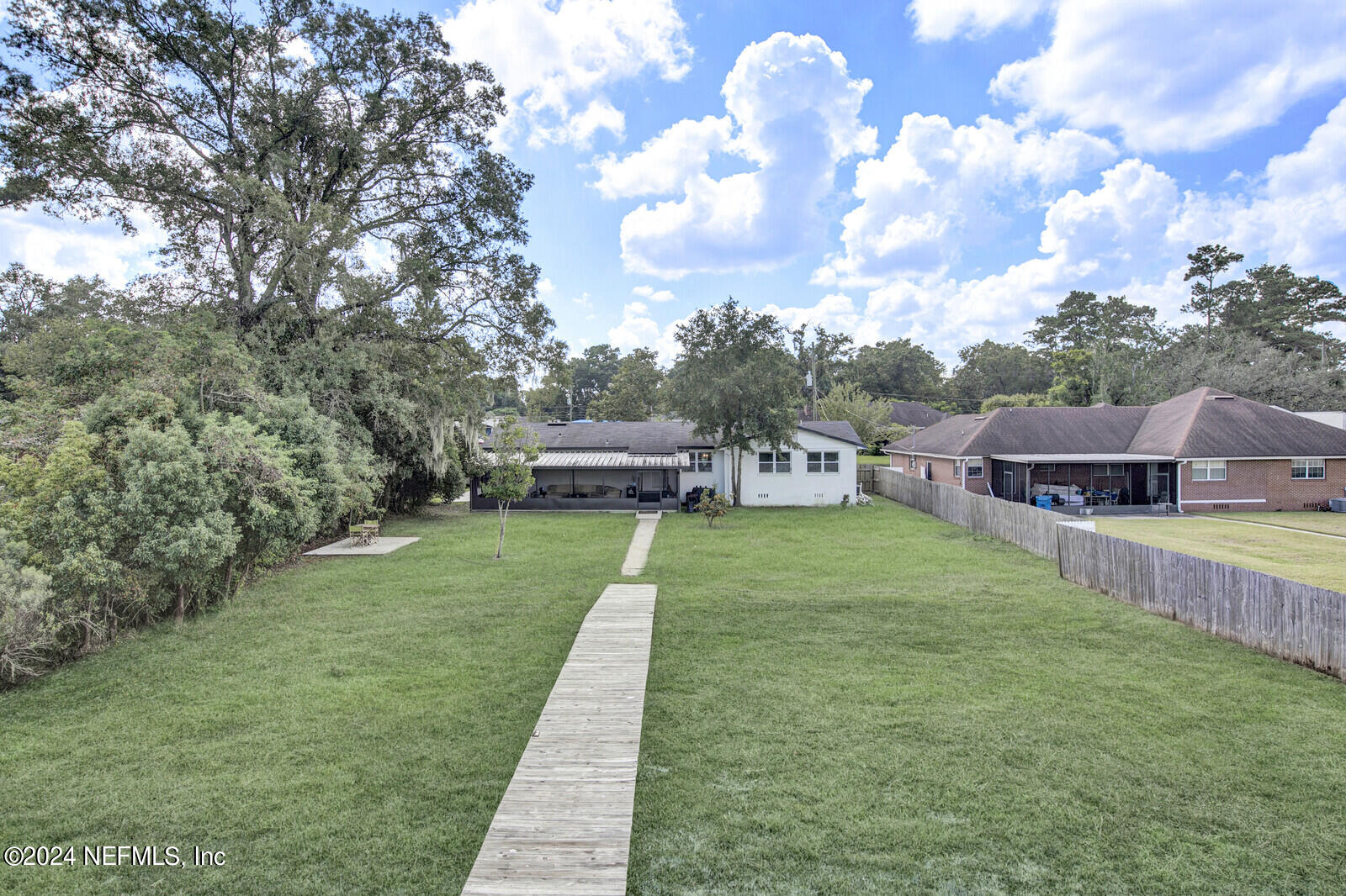 2907 Ribault Scenic Drive Jacksonville, FL 32208 - Photo 34 of 49 a view of yard with swimming pool and trees in the background