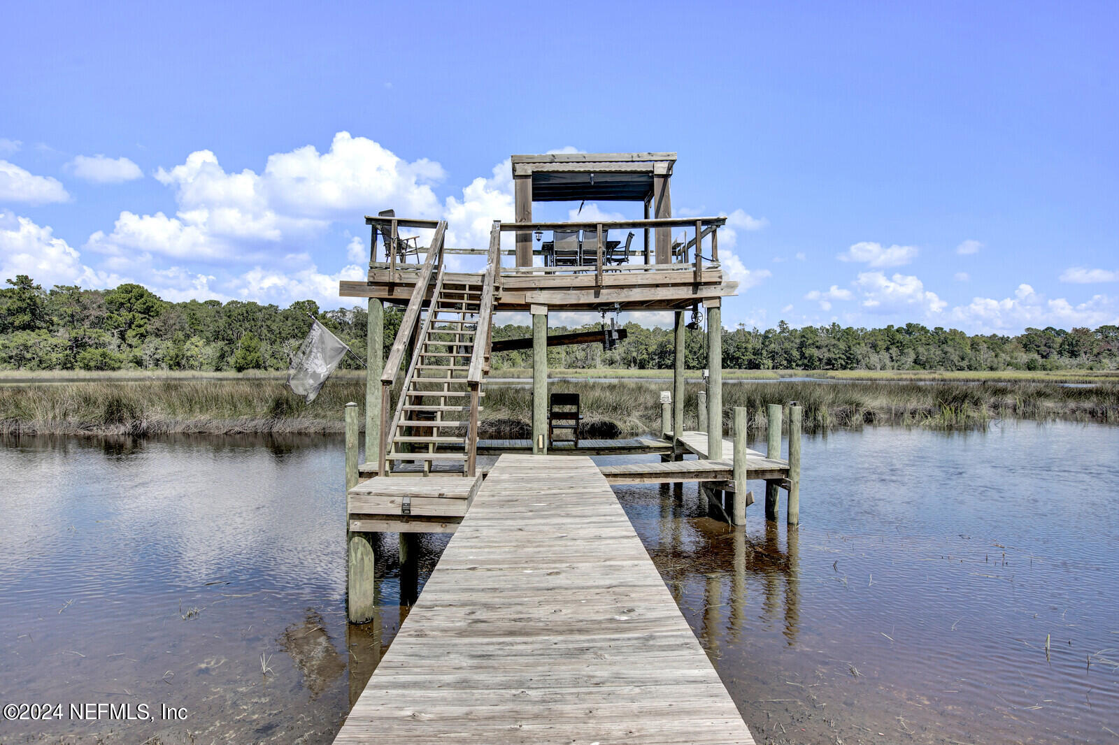 2907 Ribault Scenic Drive Jacksonville, FL 32208 - Photo 38 of 49 a view of a lake with a deck and a garden