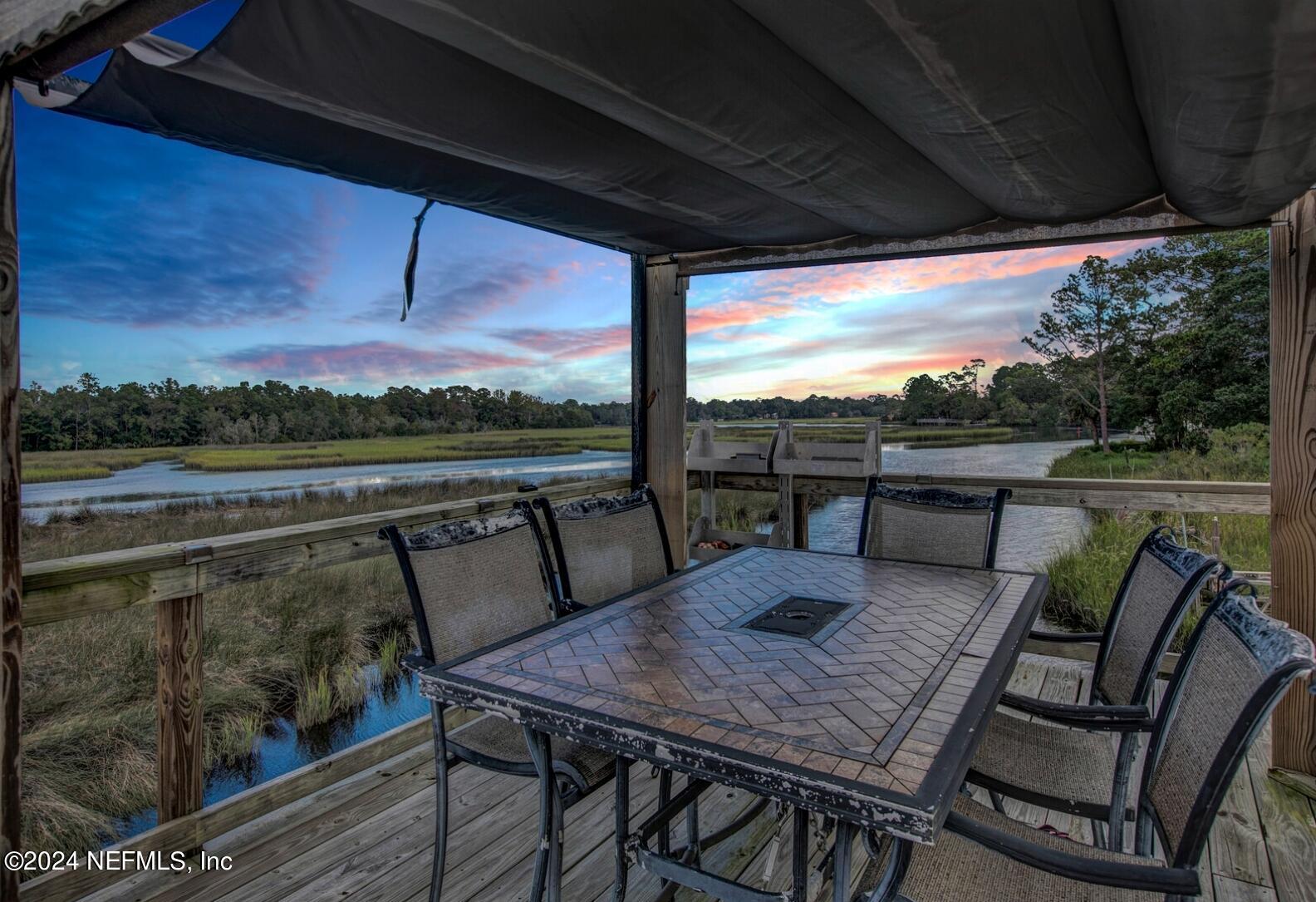 2907 Ribault Scenic Drive Jacksonville, FL 32208 - Photo 45 of 49 a view of a patio with a table chairs and a table