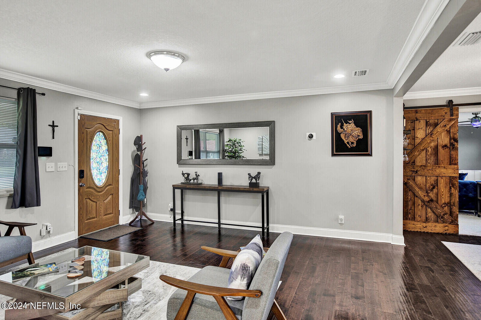 2907 Ribault Scenic Drive Jacksonville, FL 32208 - Photo 5 of 49 a living room with furniture and a flat screen tv