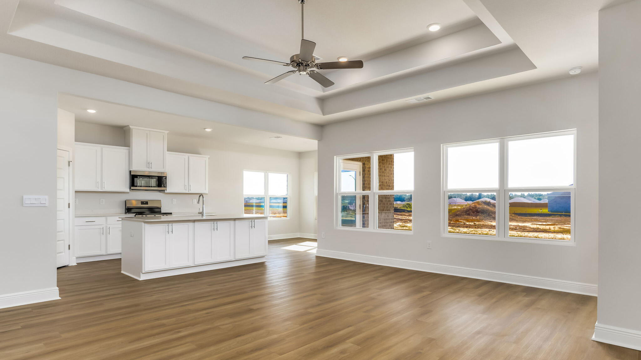 5619 Thatcher Road Crestview, FL 32539 - Photo 2 of 32 a kitchen with stainless steel appliances kitchen island wooden floors and white cabinets