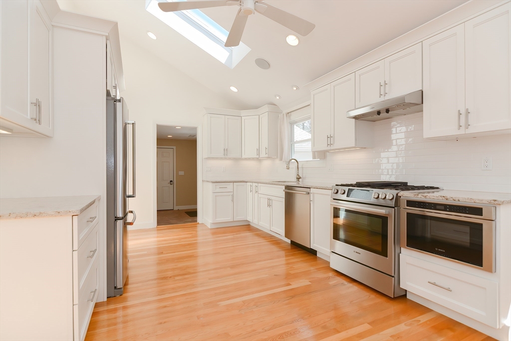 2054 Main Street Concord, MA 01742 - Photo 15 of 41 a kitchen with stainless steel appliances white cabinets and a refrigerator
