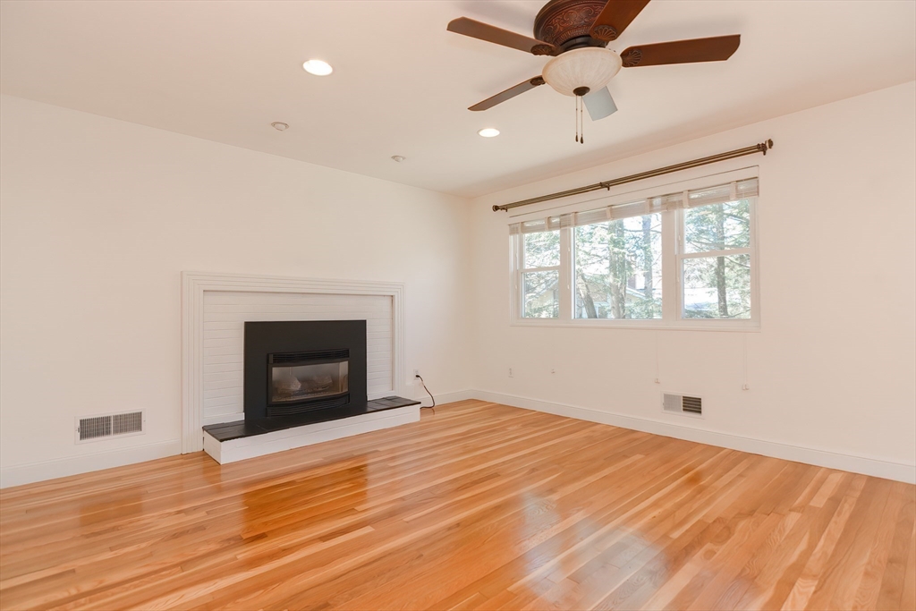 2054 Main Street Concord, MA 01742 - Photo 17 of 41 a view of empty room with wooden floor and fan