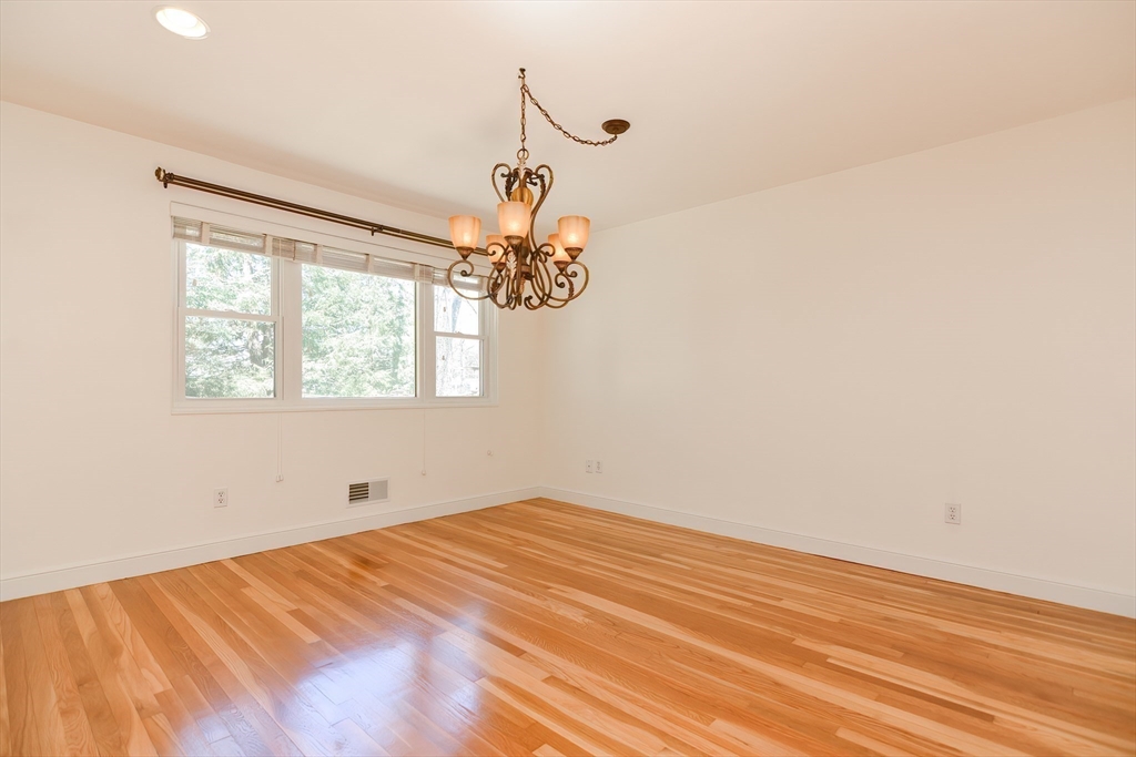 2054 Main Street Concord, MA 01742 - Photo 18 of 41 wooden floor in an empty room with a window