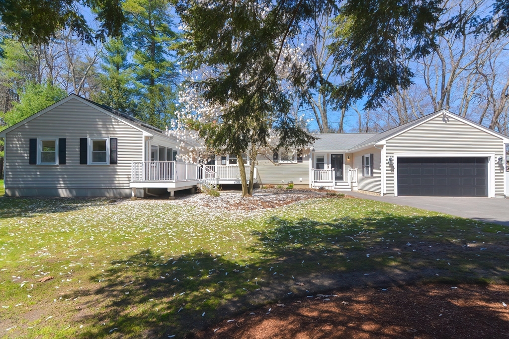 2054 Main Street Concord, MA 01742 - Photo 2 of 41 a front view of a house with a garden