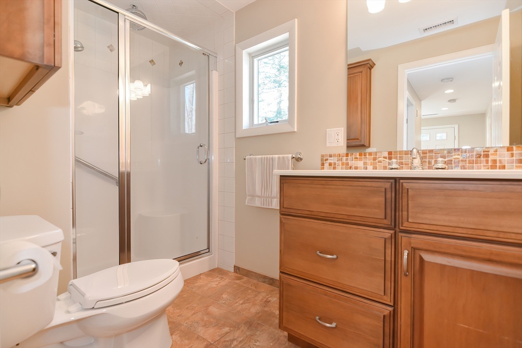 2054 Main Street Concord, MA 01742 - Photo 23 of 41 a bathroom with a sink a toilet and shower