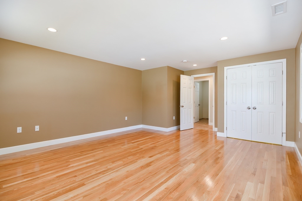 2054 Main Street Concord, MA 01742 - Photo 25 of 41 a view of an empty room with wooden floor and closet