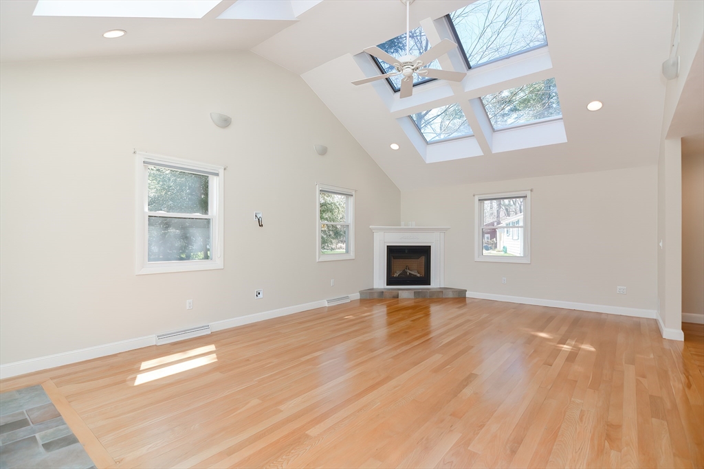 2054 Main Street Concord, MA 01742 - Photo 30 of 41 a view of an empty room with chandelier fan and fire place