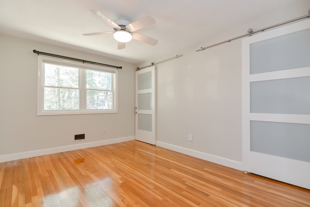 2054 Main Street Concord, MA 01742 - Photo 33 of 41 a view of an empty room with wooden floor and a window