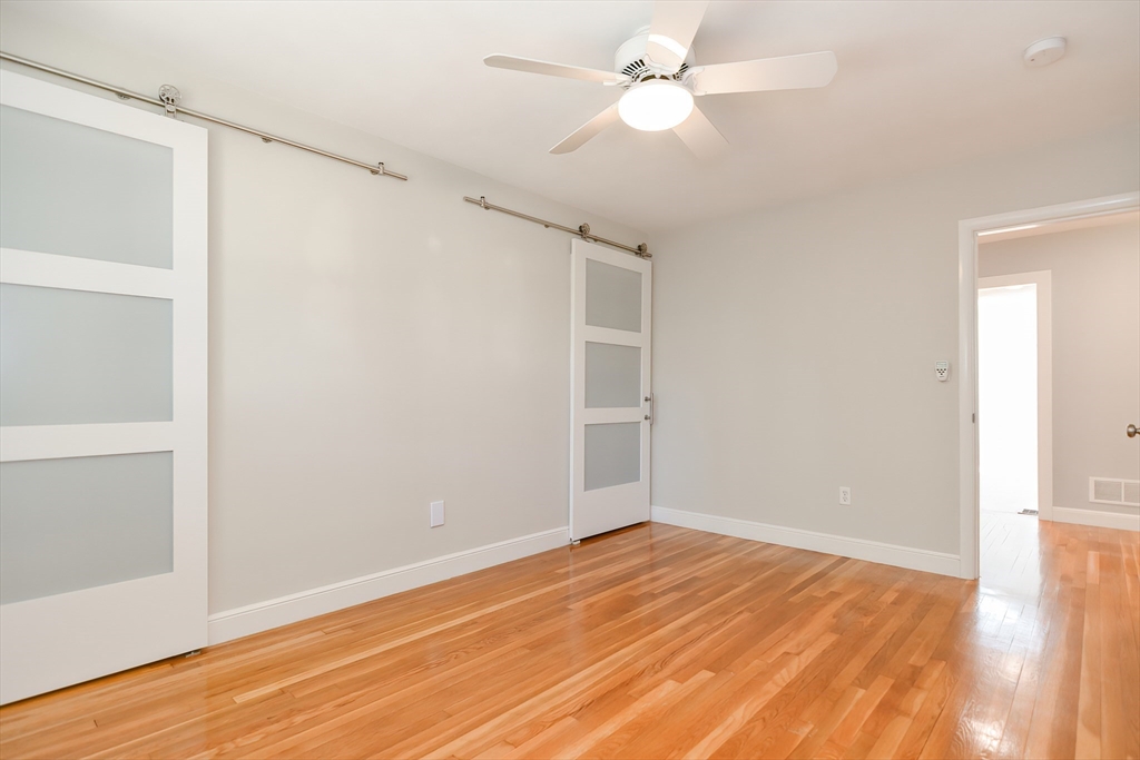 2054 Main Street Concord, MA 01742 - Photo 34 of 41 a view of empty room with wooden floor and fan