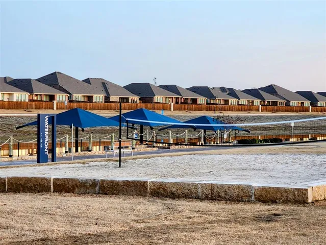 a view of a big building with big yard and large trees