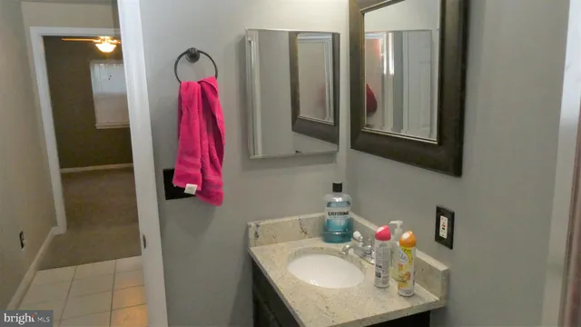 a bathroom with a sink vanity and a mirror