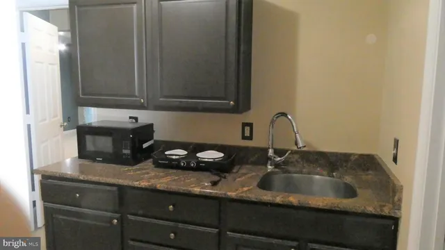 a bathroom with a sink mirror and shower