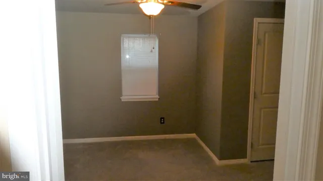 a view of an empty room with a fan