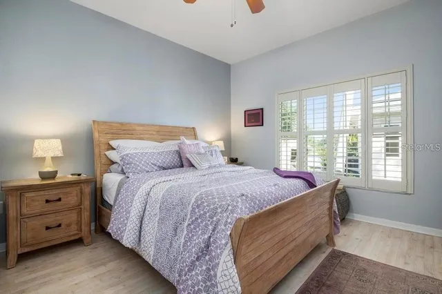 a bed sitting in a bedroom next to a window