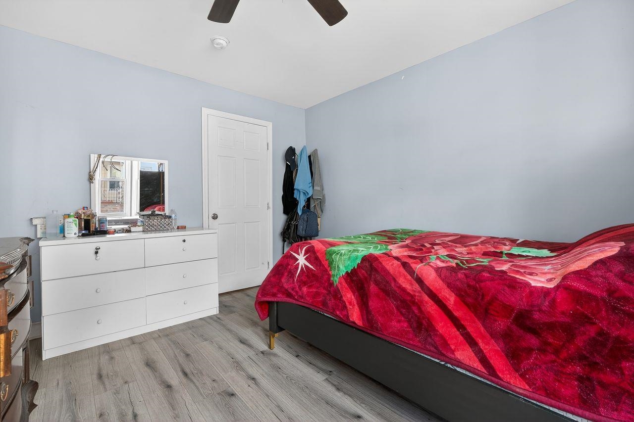 229 Patterson Street Harrison, NJ 07029 - Photo 8 of 26 a bedroom with a bed and a mirror