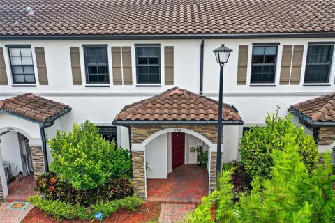 front view of a house with potted plants