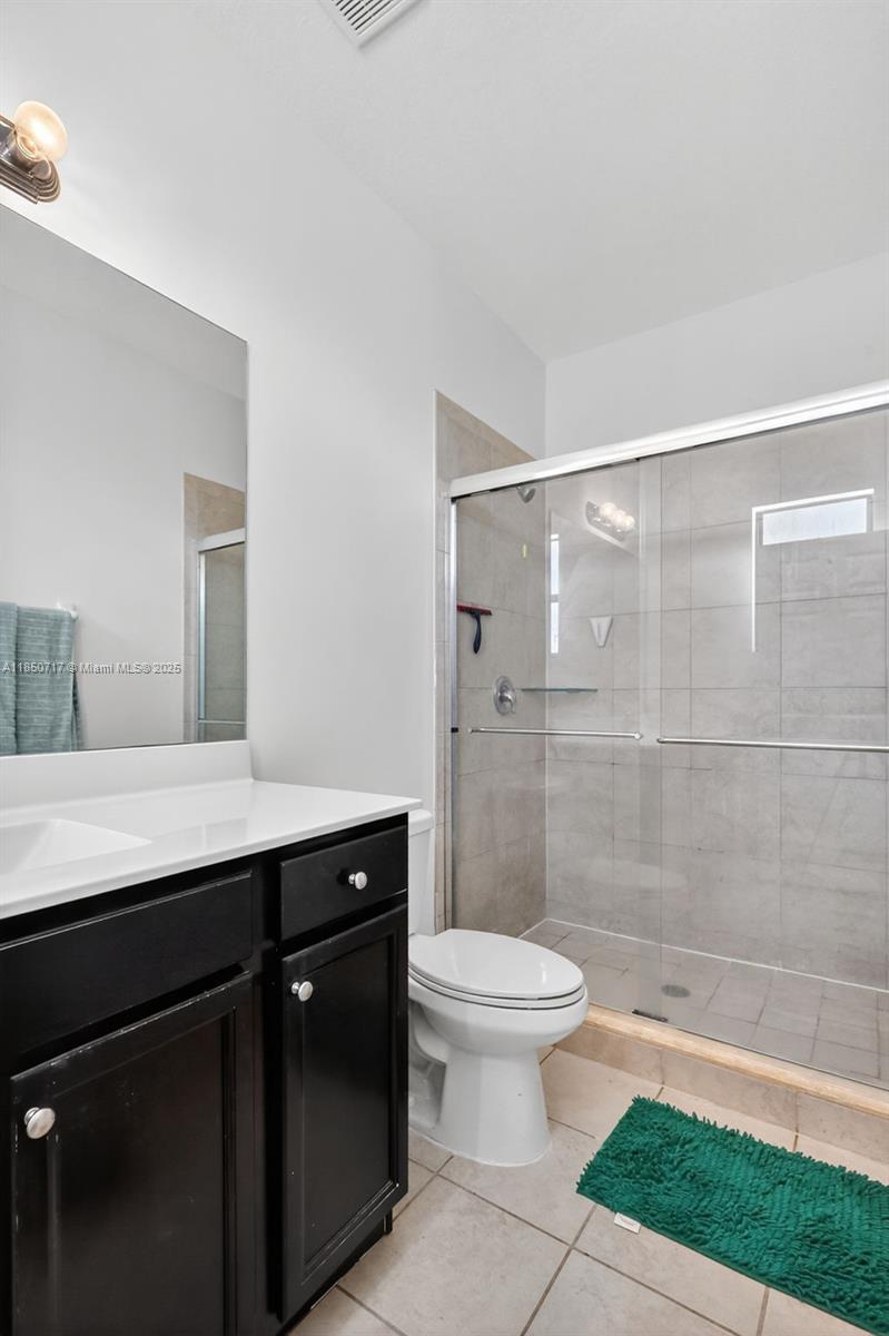 11418 Southwest 250th Street Homestead, FL 33032 - Photo 21 of 60 a bathroom with a sink a toilet a shower and a mirror