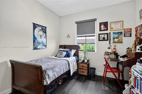 a view of a livingroom with furniture window and kitchen view