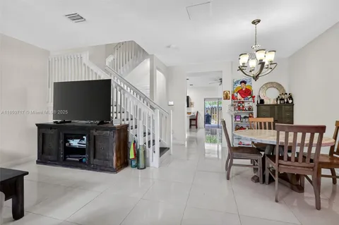 a view of a dining room with furniture wooden floor and a flat screen tv