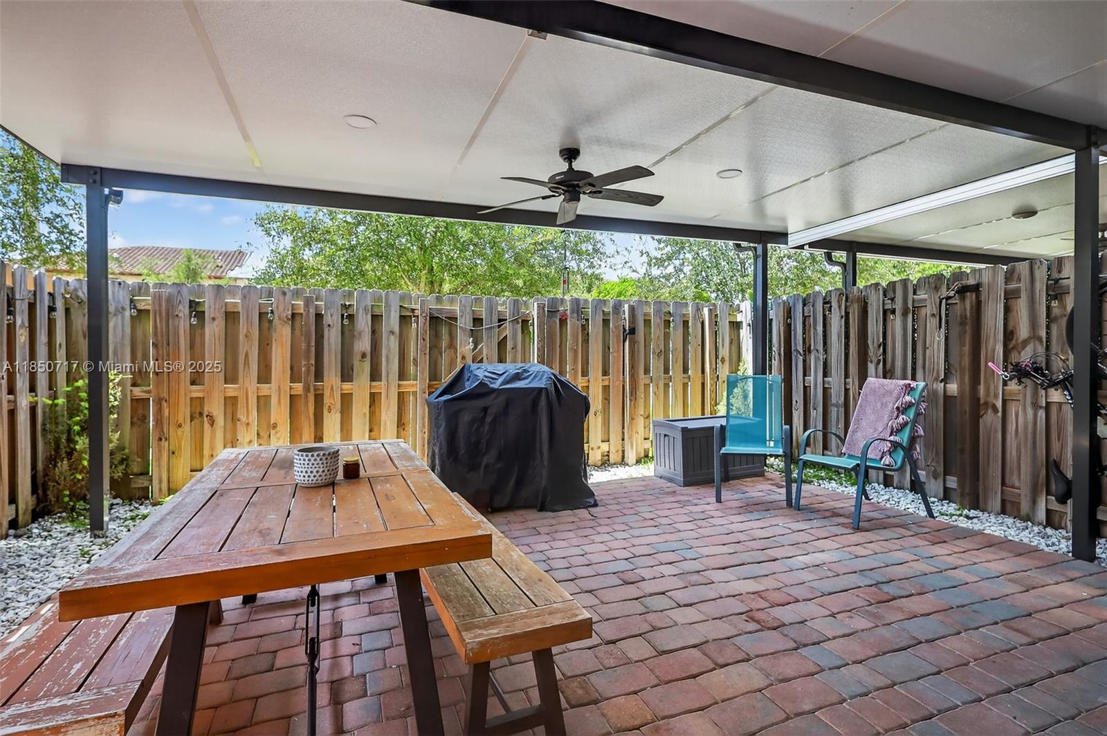 11418 Southwest 250th Street Homestead, FL 33032 - Photo 42 of 60 a view of a patio with a table and chairs