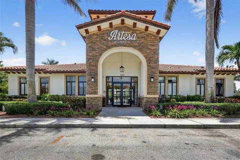 an aerial view of a house with garden space and lake view
