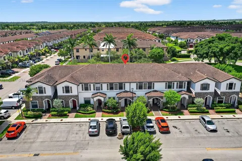 an aerial view of a house with garden space and street view