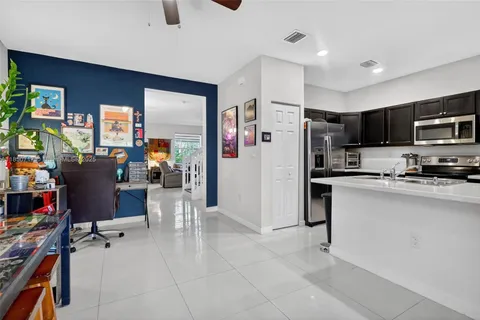 a kitchen with stainless steel appliances a sink a stove a refrigerator a washer dryer and a refrigerator