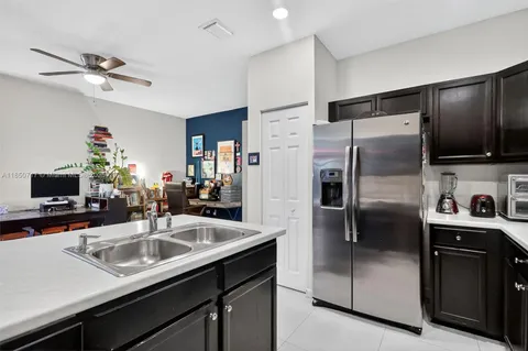a kitchen with stainless steel appliances a refrigerator sink stove and microwave