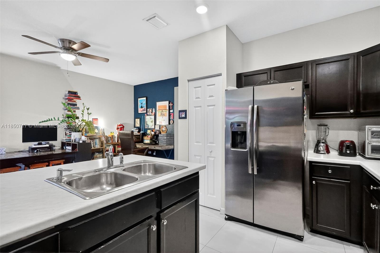 11418 Southwest 250th Street Homestead, FL 33032 - Photo 8 of 60 a kitchen with stainless steel appliances a sink a stove a refrigerator a washer dryer and a refrigerator