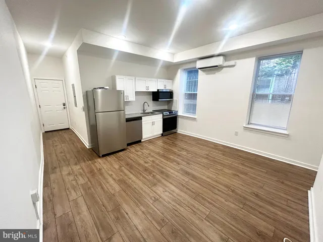 a kitchen with a refrigerator and a stove top oven