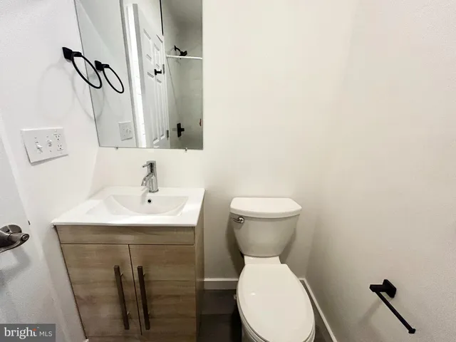 a bathroom with a sink a toilet and mirror