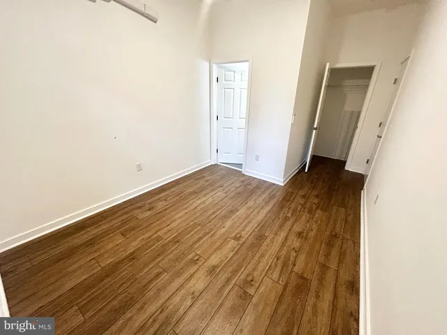 an empty room with wooden floor