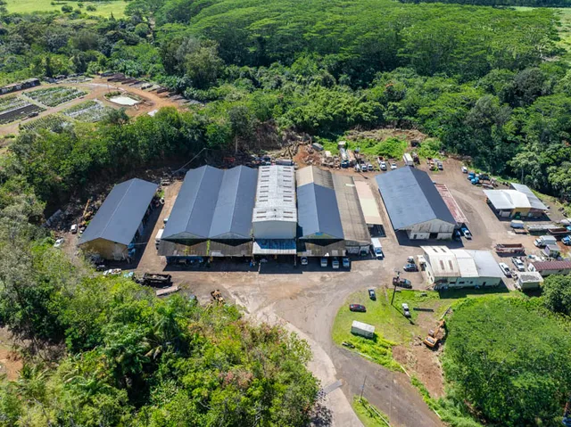 an aerial view of a house with garden space and street view